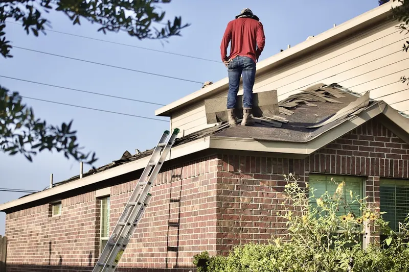 Professional roofer working on a residential roof in Portage Lakes